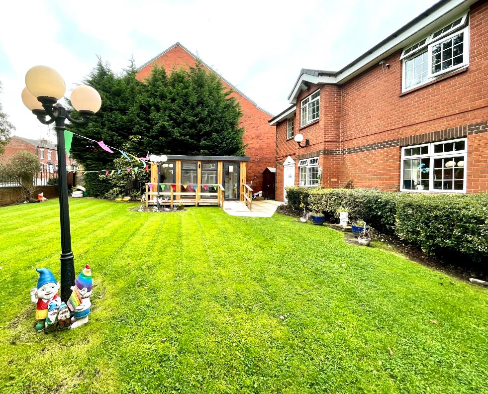 care home garden lawn with gnomes